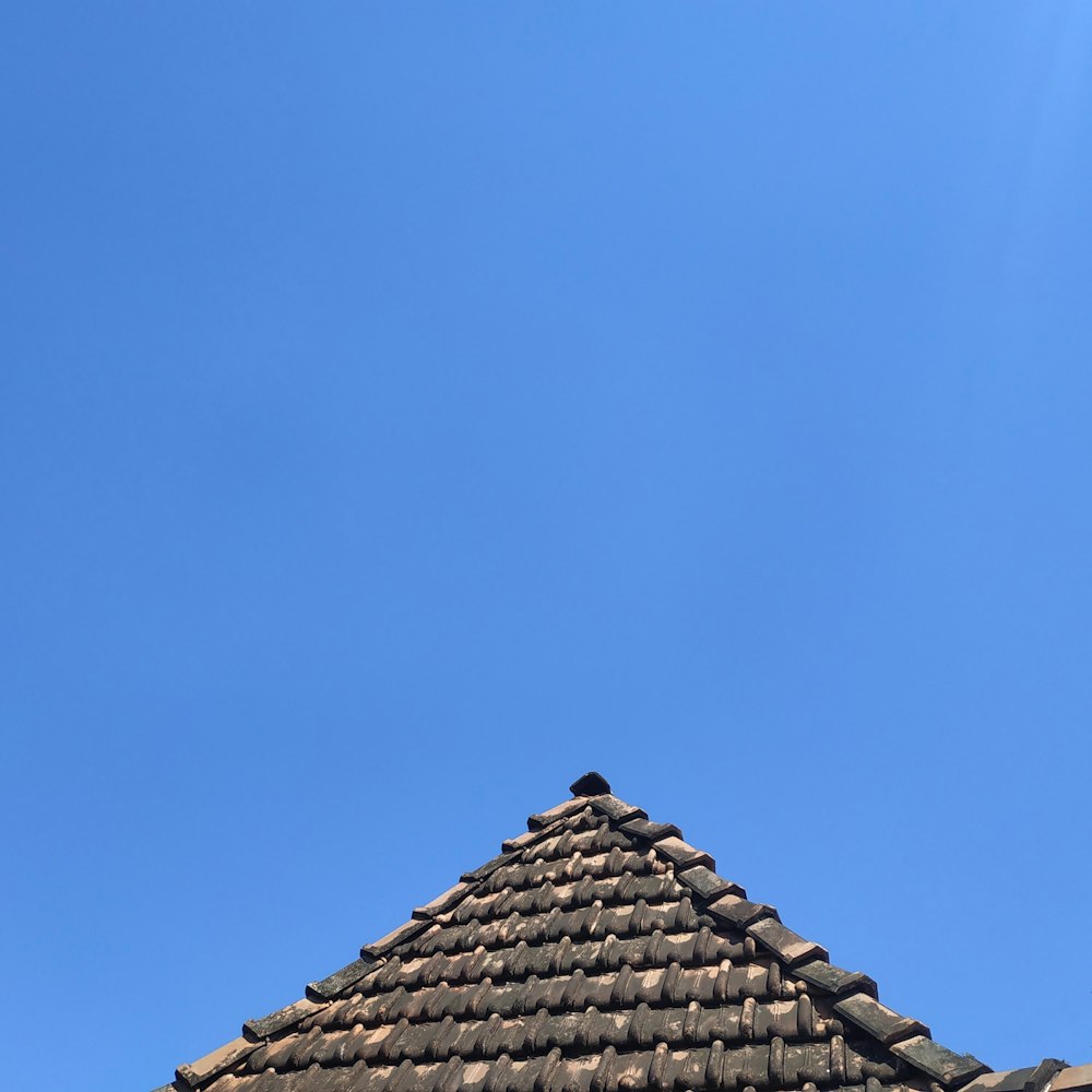 the top of a roof with a blue sky in the background