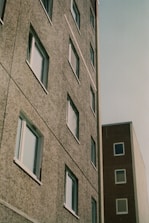 a tall building next to a tall building with windows