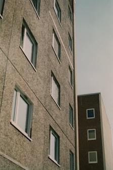 a tall building next to a tall building with windows