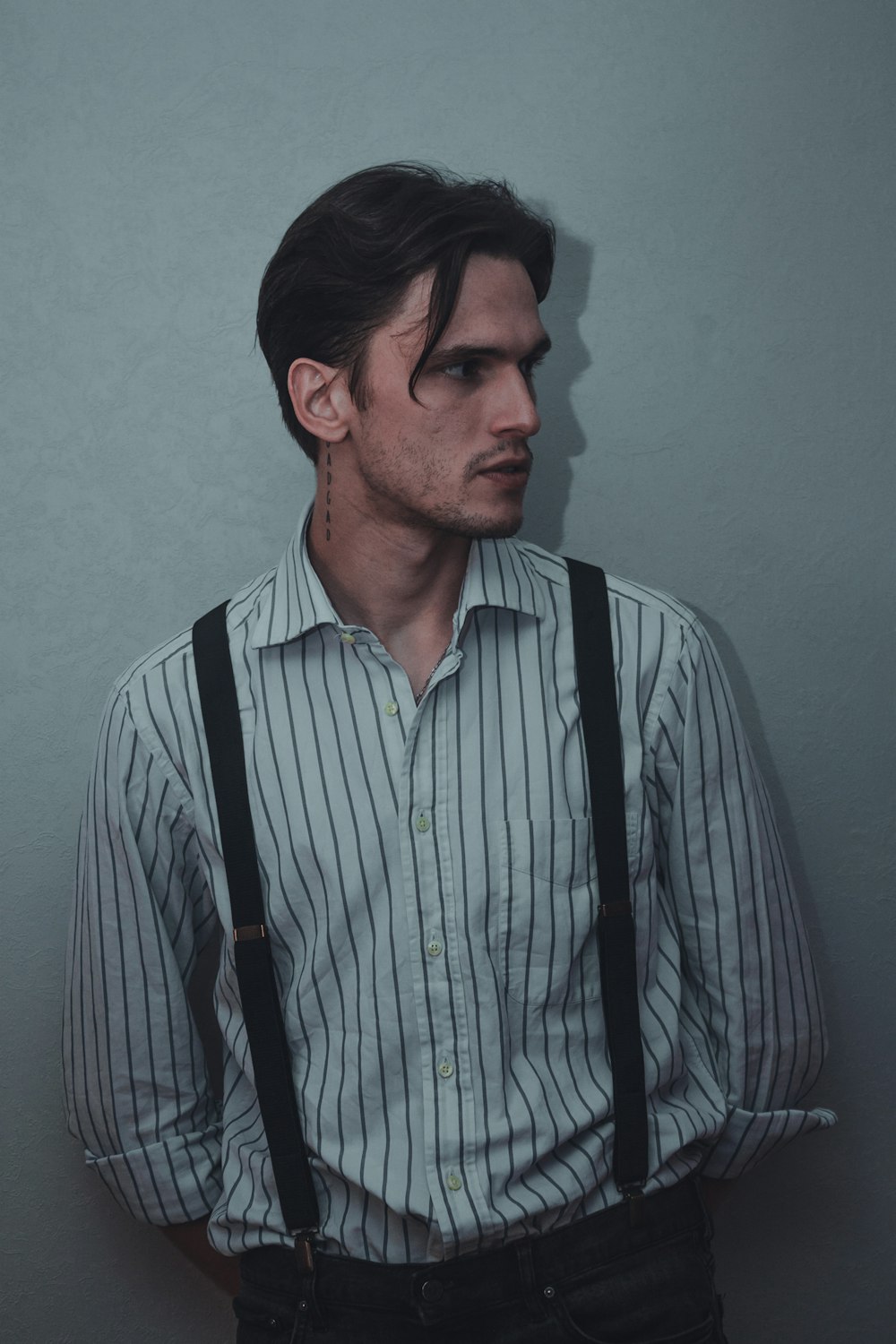 a man wearing suspenders and a striped shirt