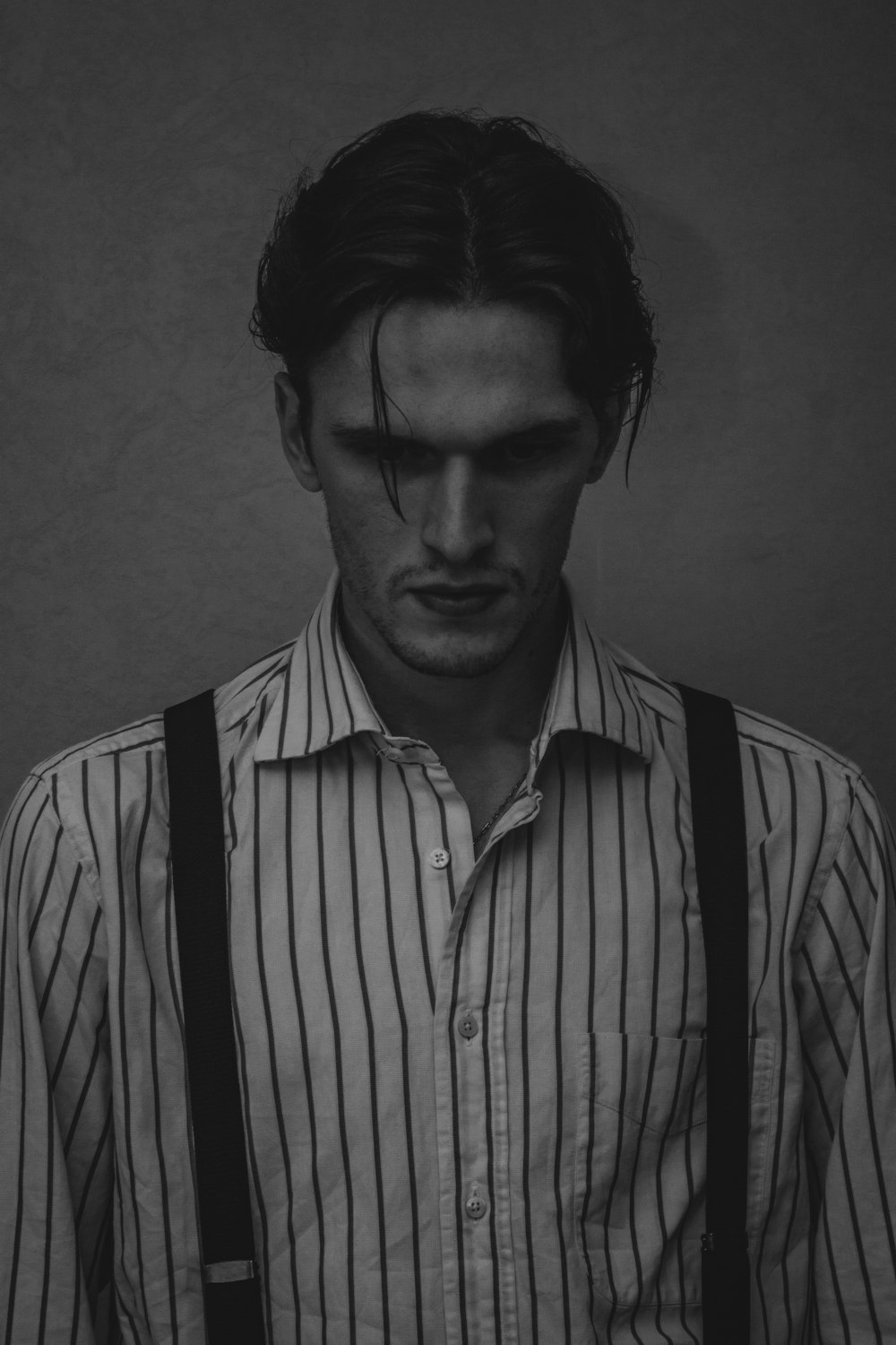 a man with suspenders and a striped shirt