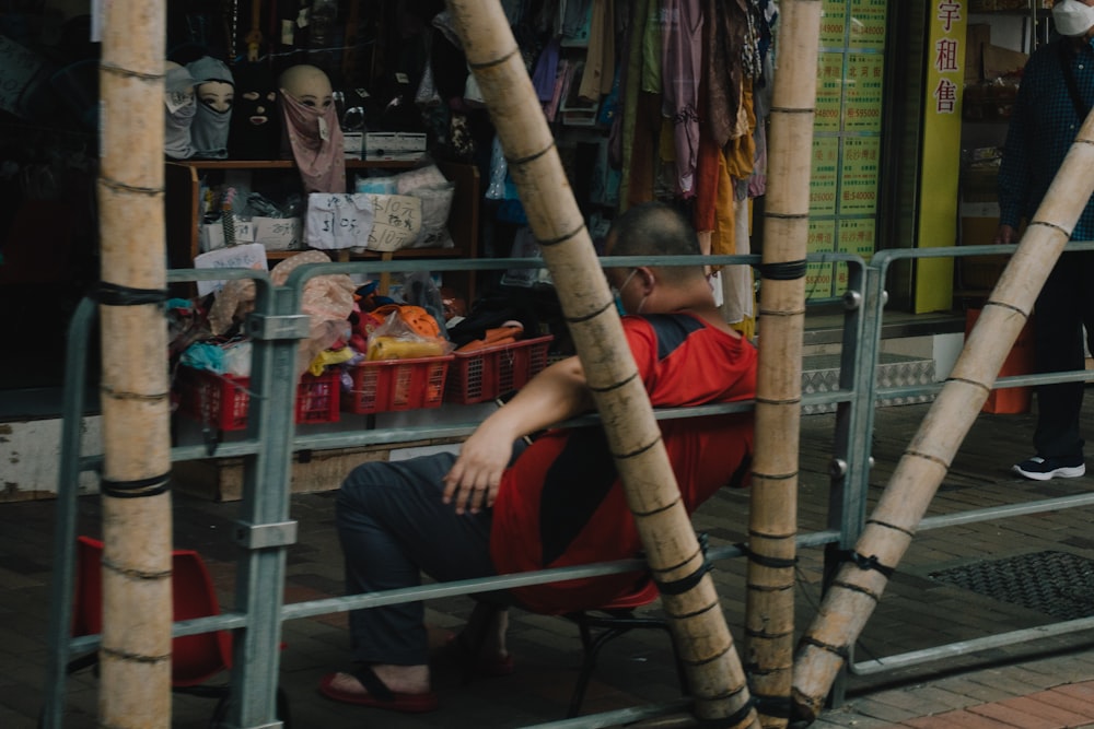 a man sitting on a chair in front of a store