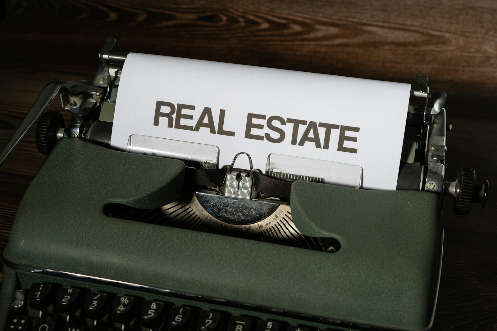 Typewriter with real estate agreement paperwork