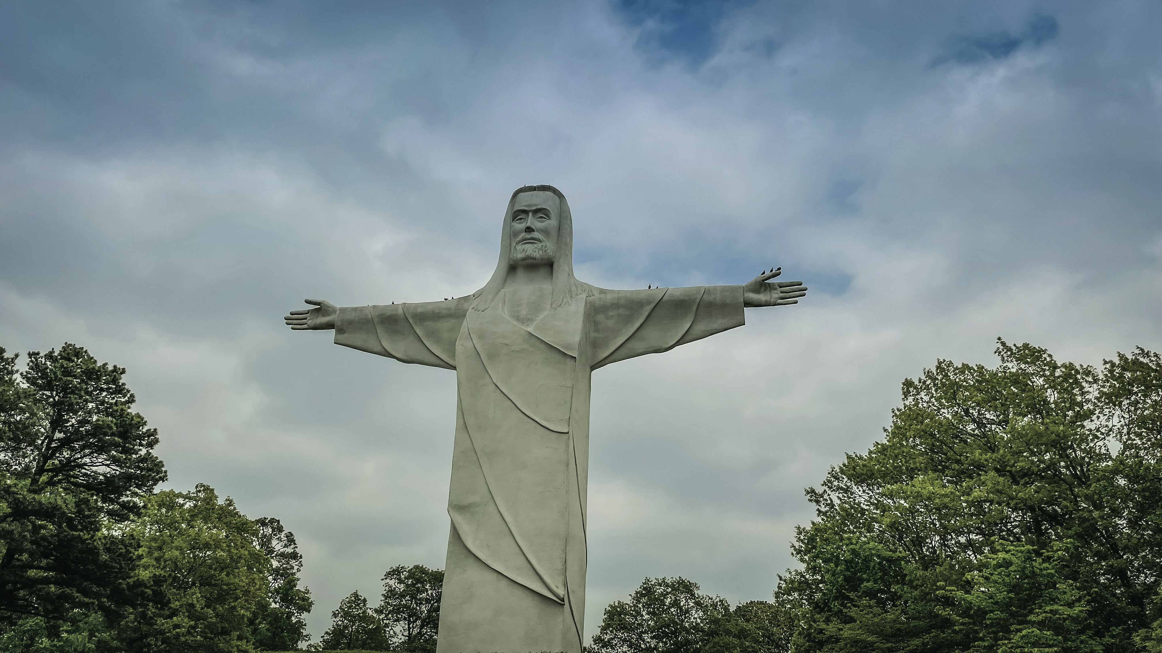 a large statue of jesus in a park