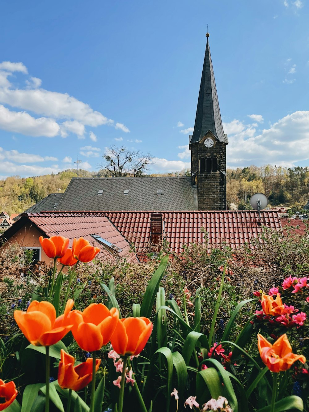 a church steeple with a clock tower in the background