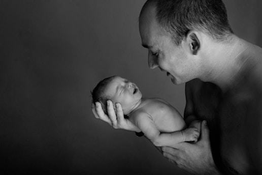 a man holding a baby in his arms