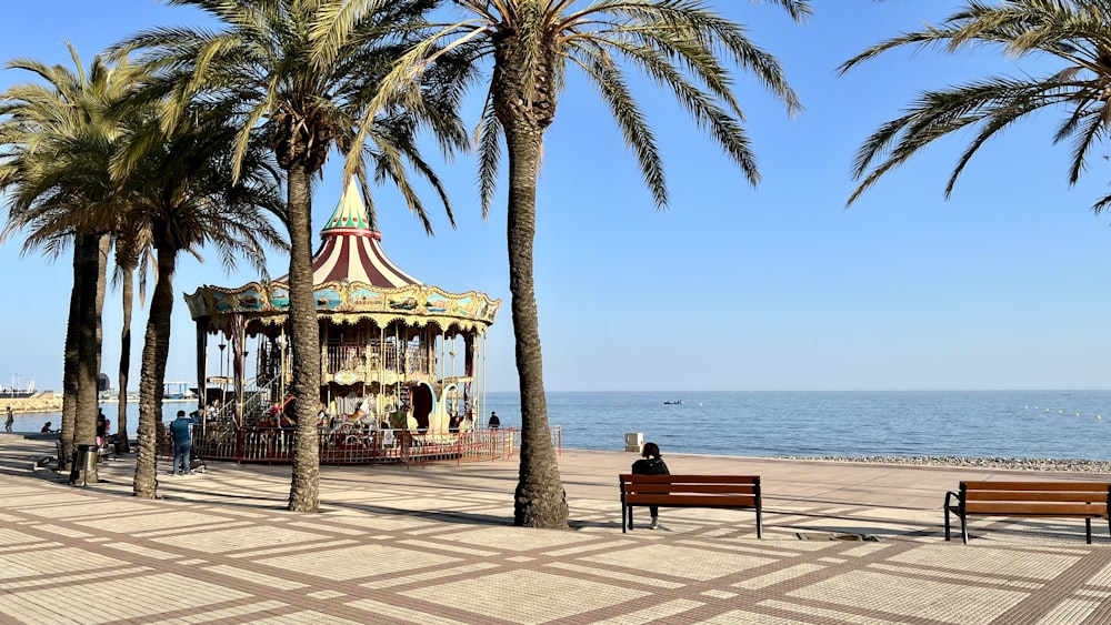 a carousel on the beach with palm trees