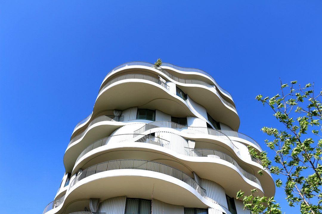 a tall building with balconies on the top of it, Folie Divine - Montpellier - 34000 - Olexandra Babii - south of France