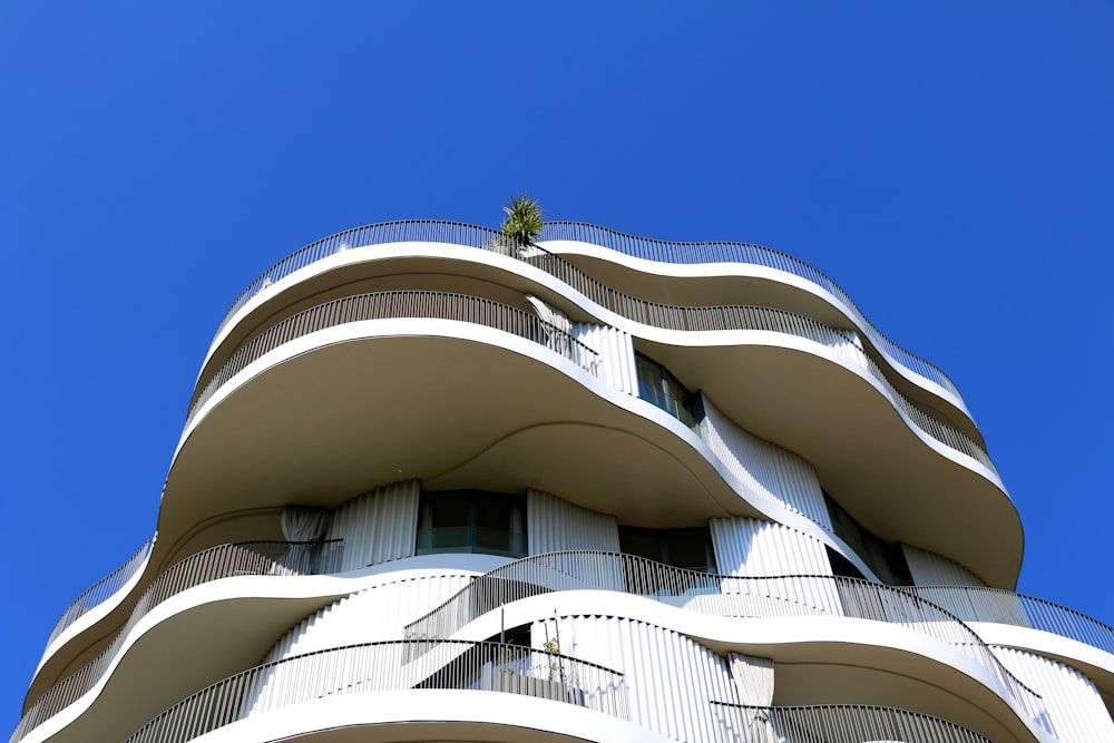 a tall white building with balconies and balconies