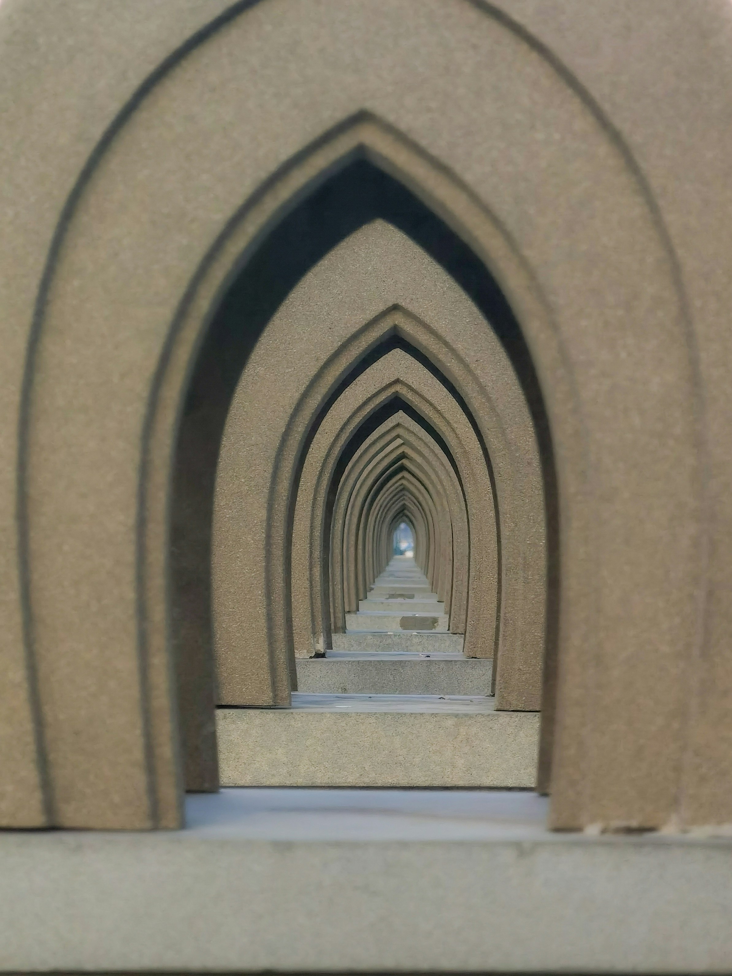 a close up of a stone arch with a clock on it