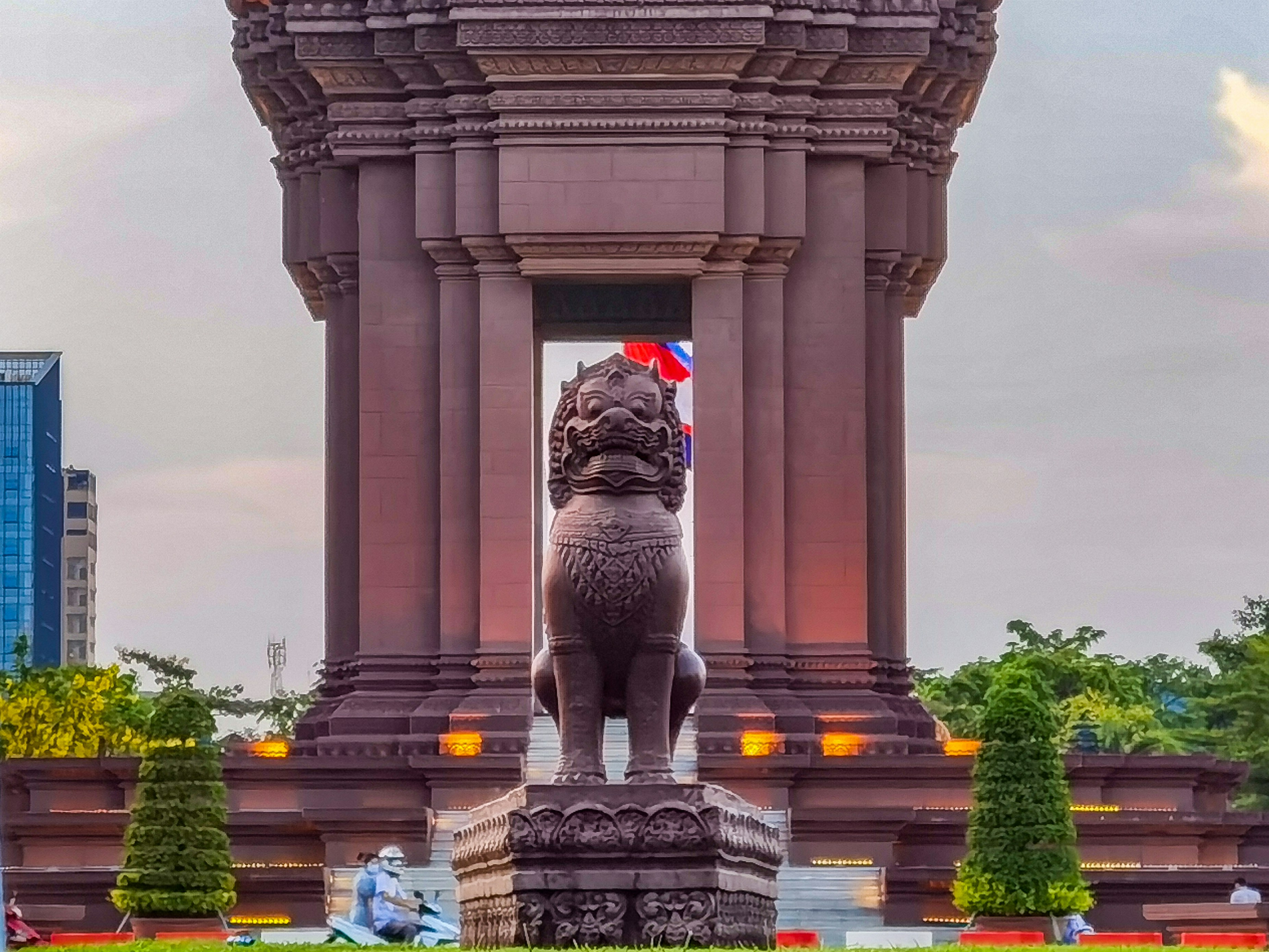 a statue of a lion in front of a tall building