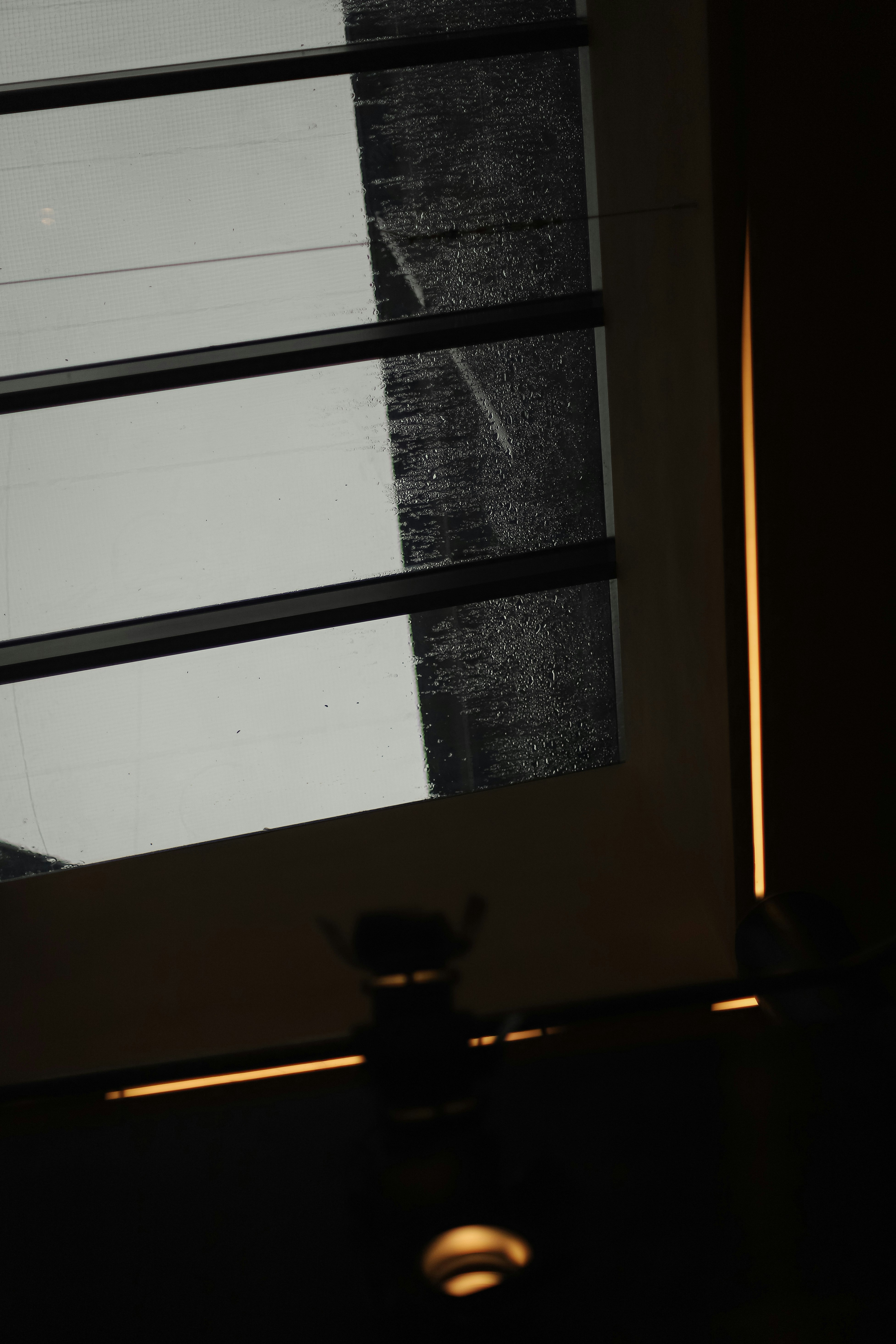 a black and white photo of a window and a light