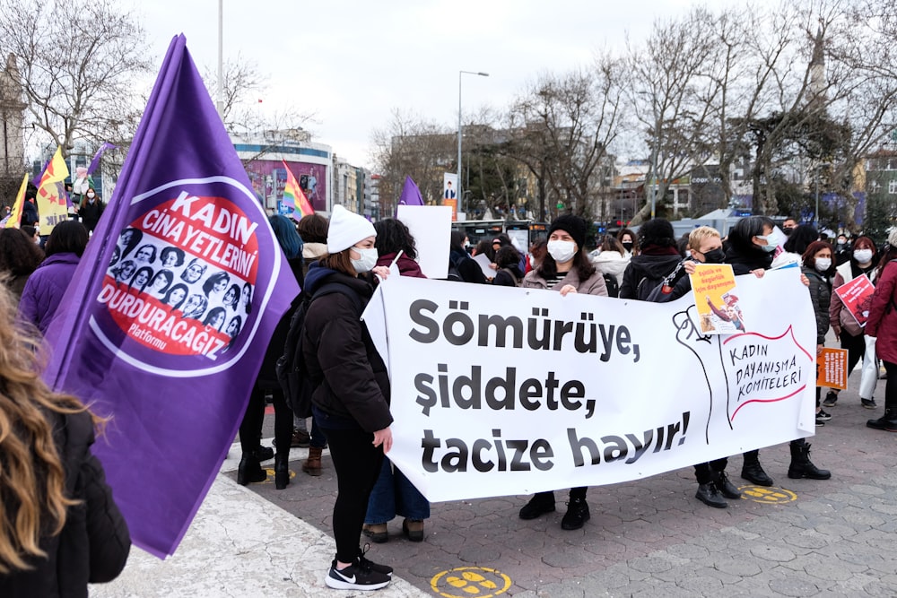 a group of people holding a protest sign