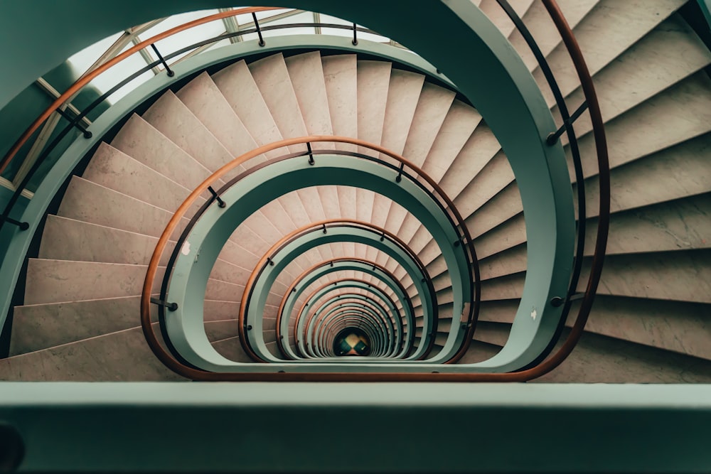 a spiral staircase in a building with a skylight