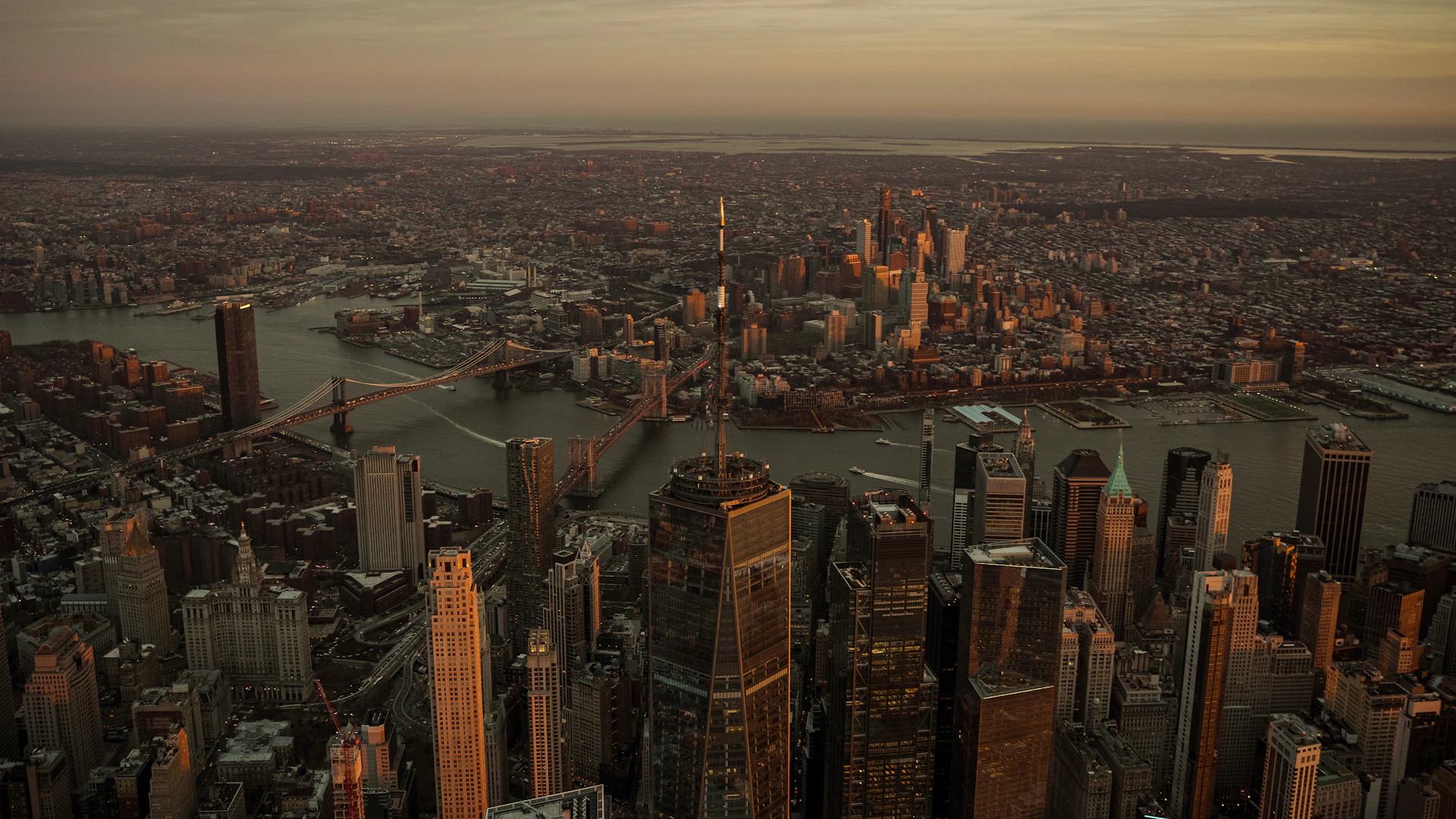 an aerial view of a city at sunset
