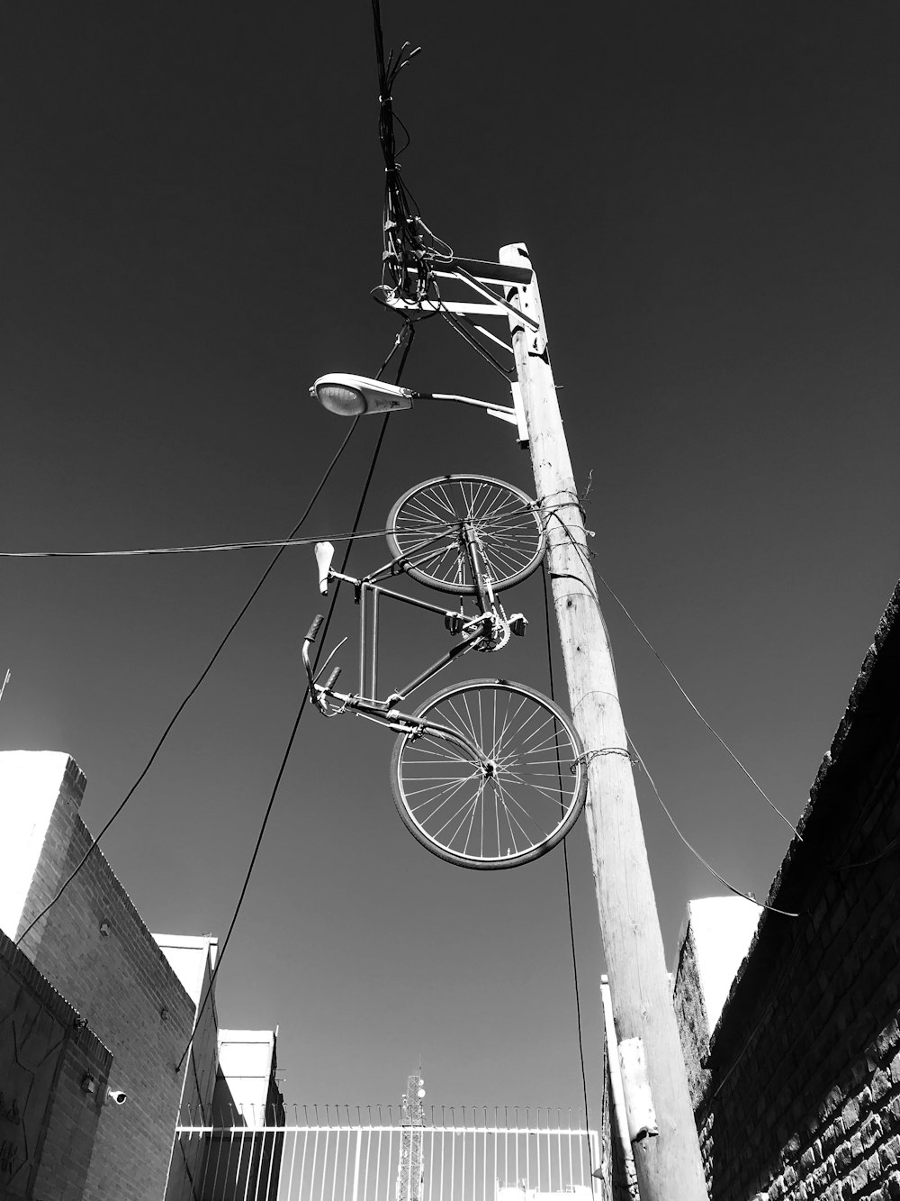 a black and white photo of a bicycle on a pole