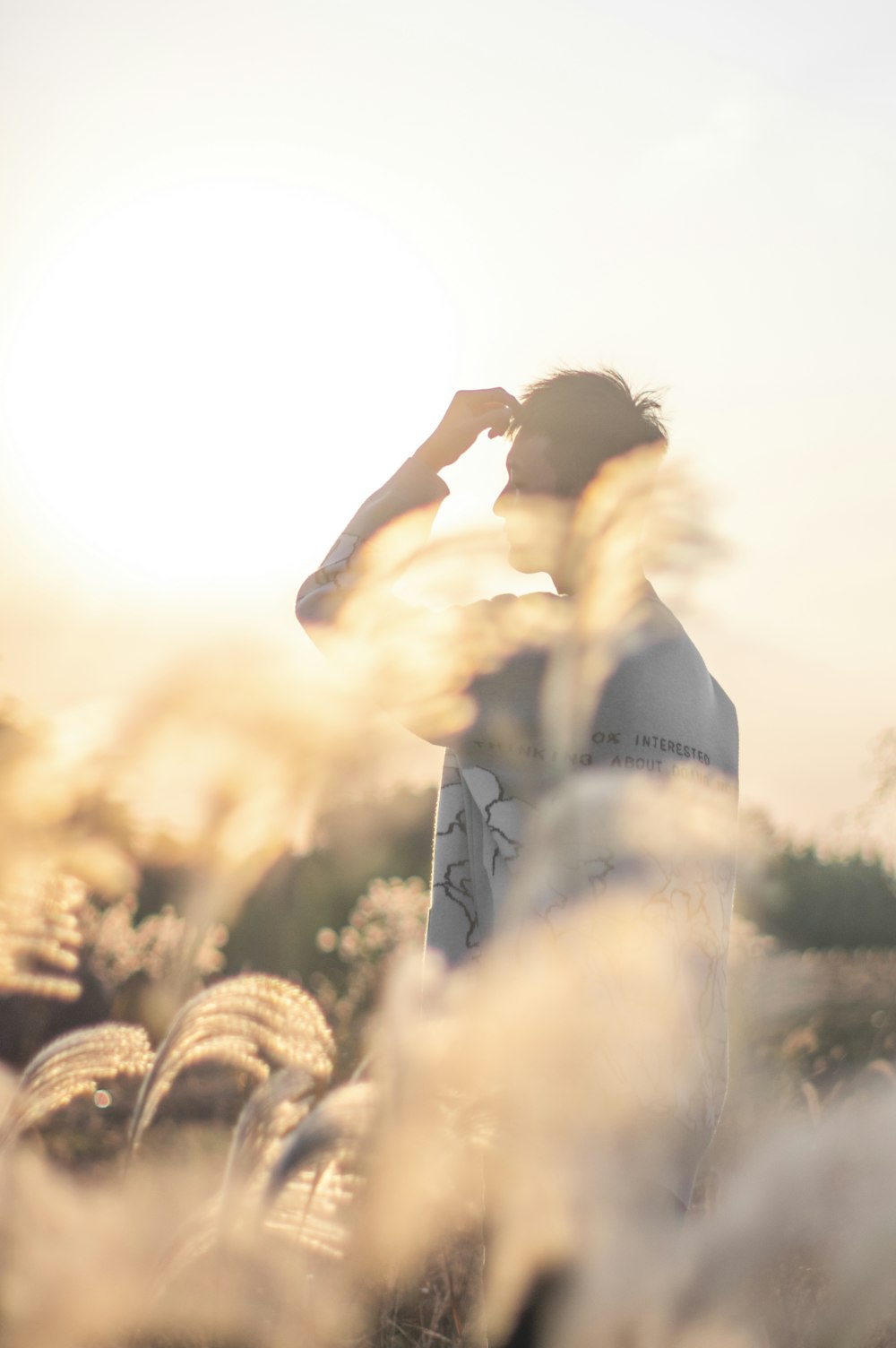 a man standing in a field of tall grass