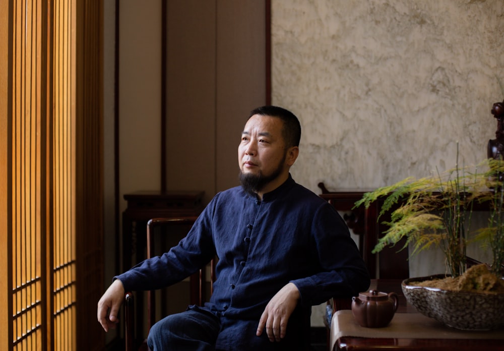 a man sitting in a chair in a room