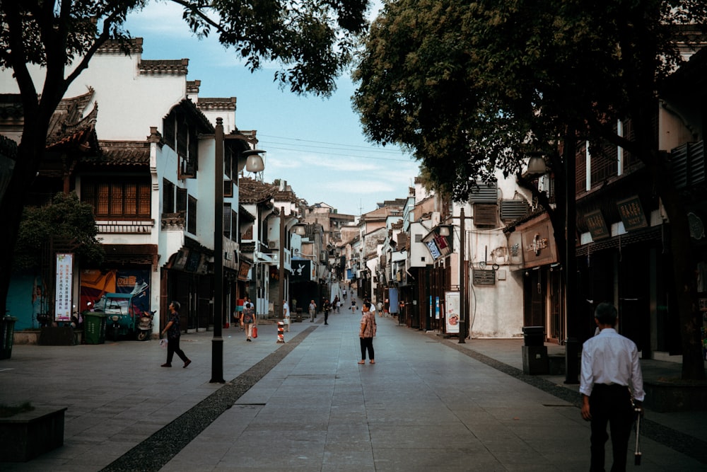 a couple of people that are walking down a street