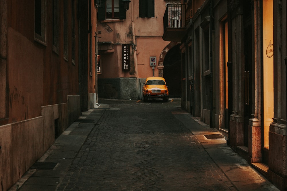 a car parked on the side of a narrow street