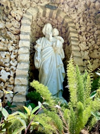 a statue of a woman in a garden