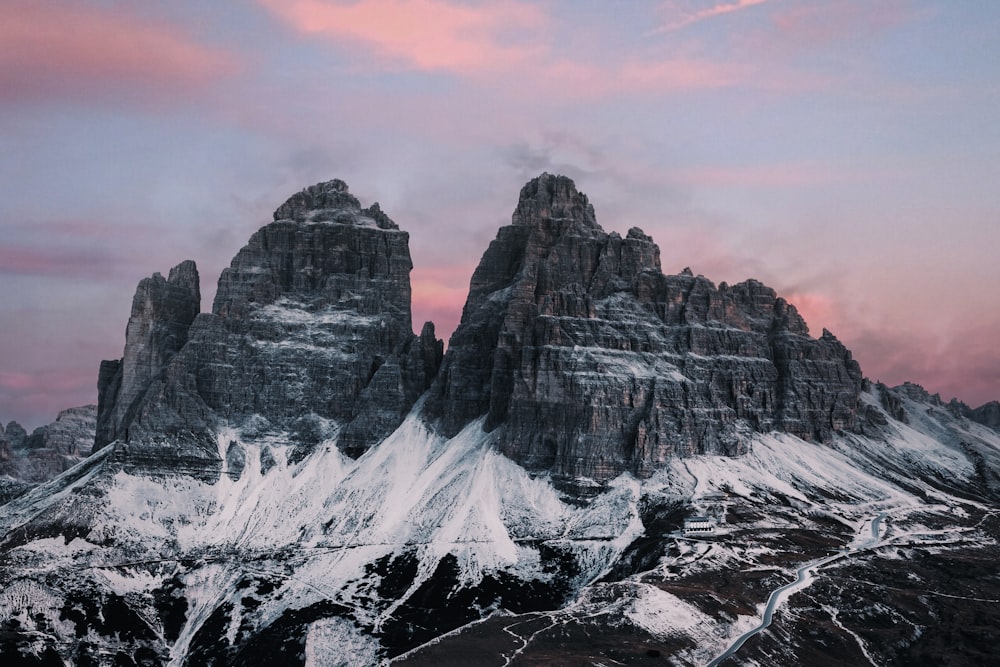 a mountain range with a pink sky in the background