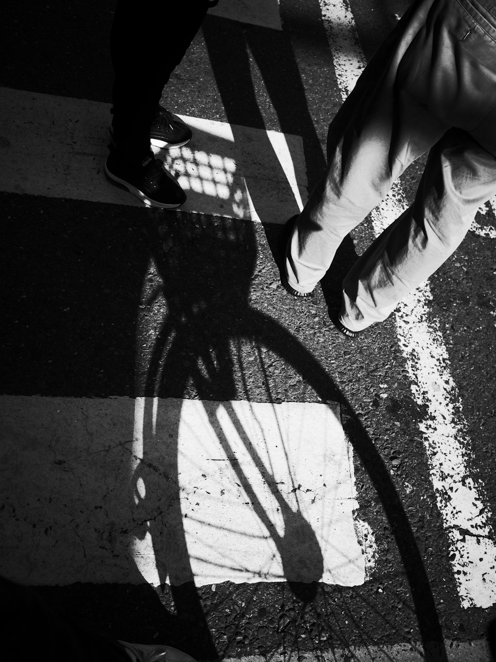 a person standing next to a bike on a street