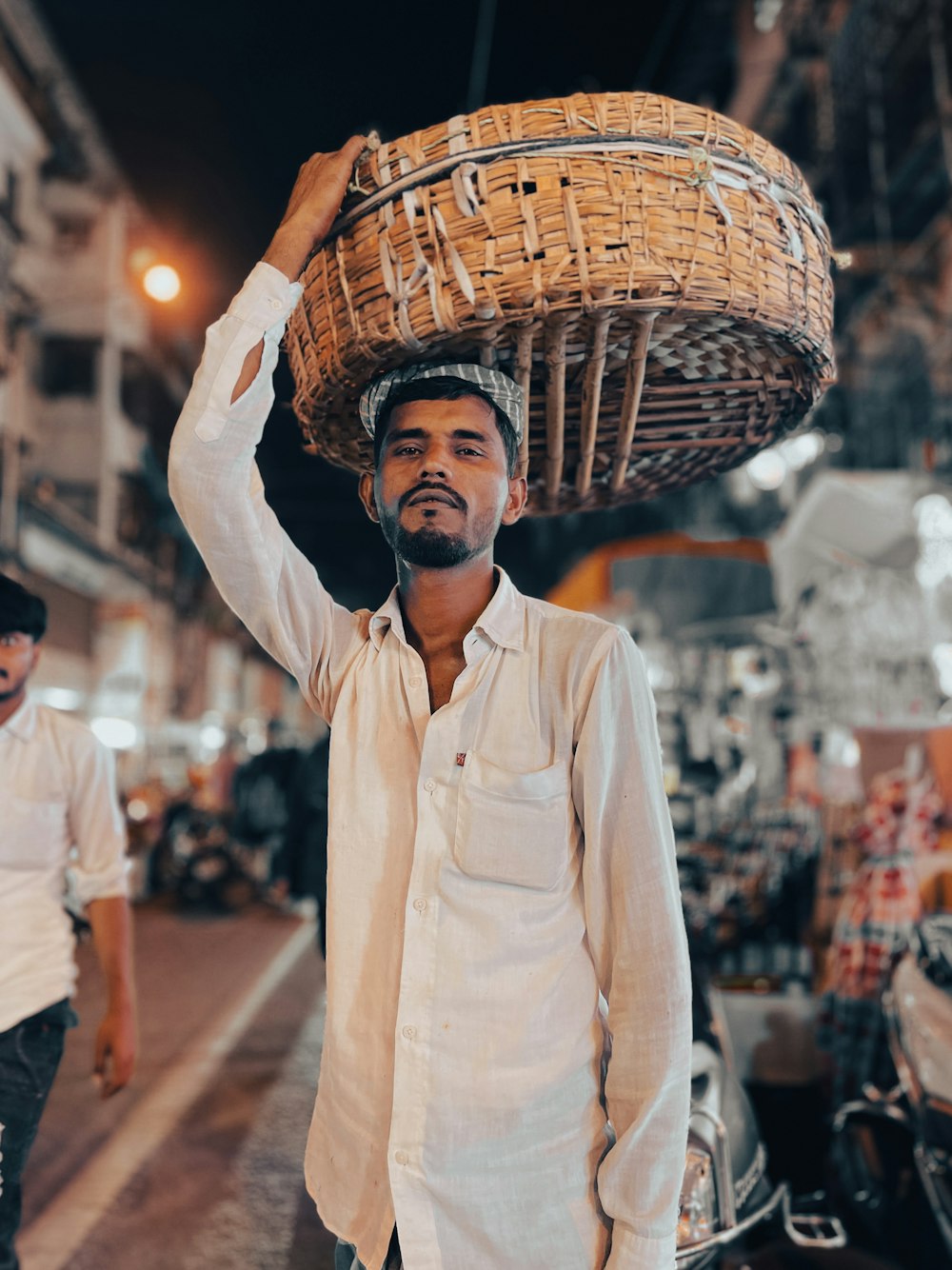 a man carrying a basket on his head