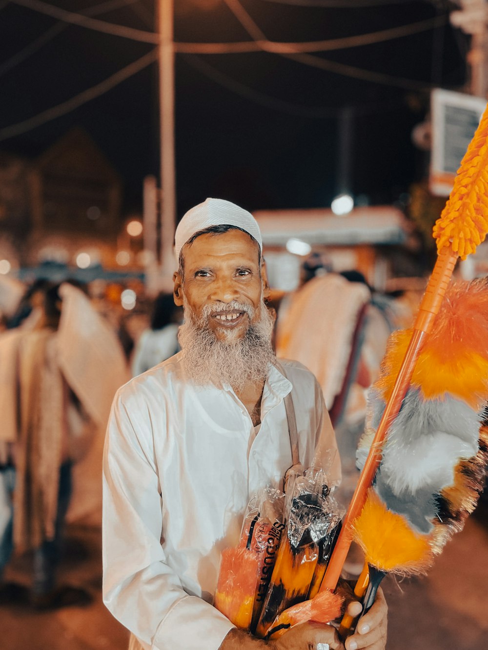 a man with a white beard holding a broom