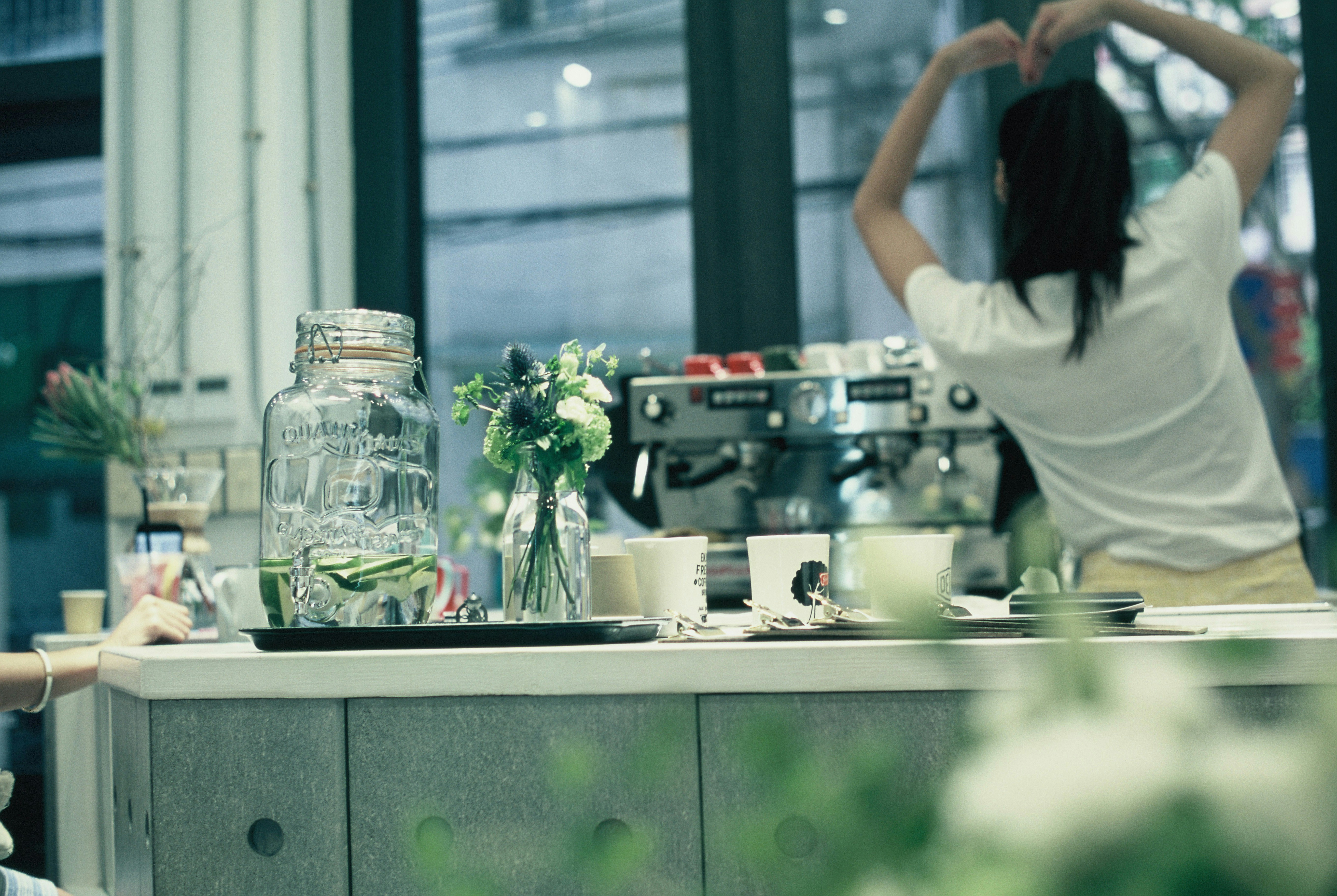 a woman sitting at a counter in a coffee shop
