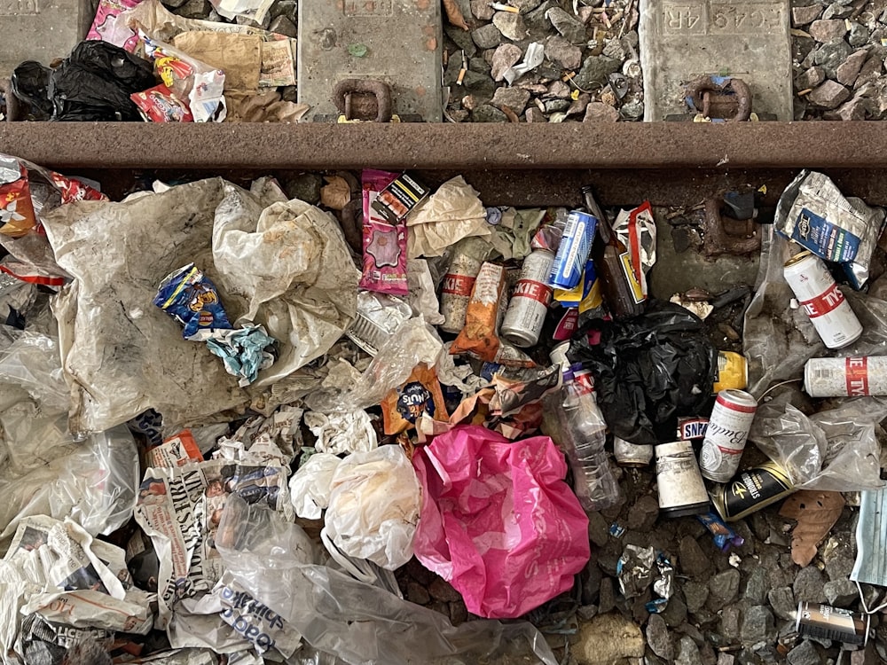a pile of trash sitting on top of a sidewalk