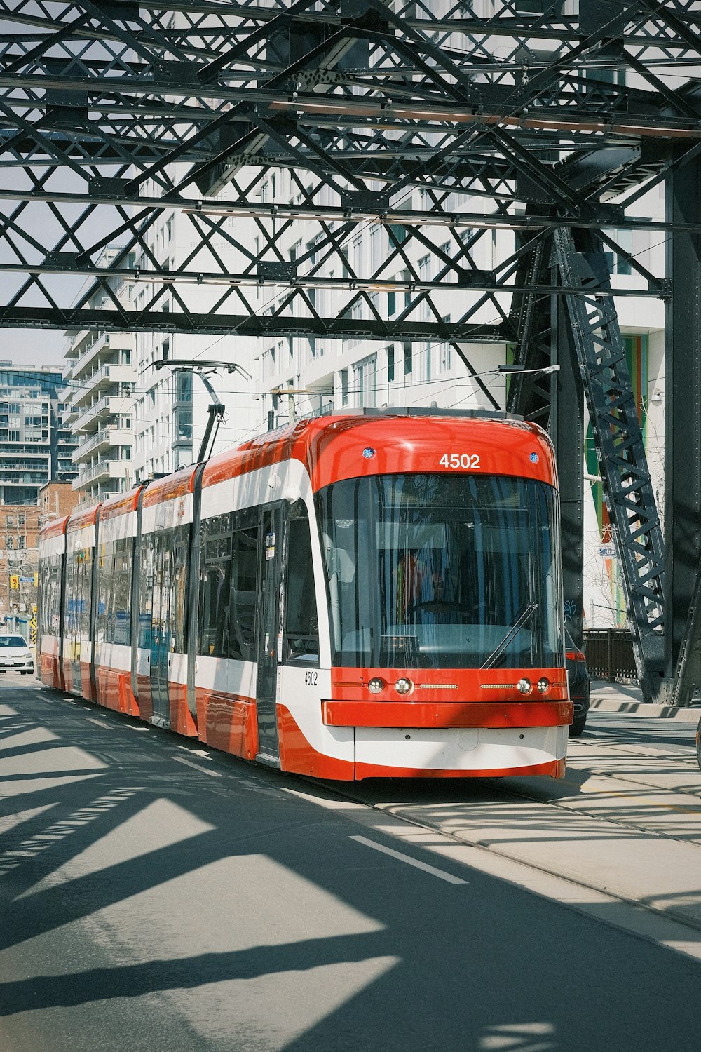 a red and white train traveling down train tracks