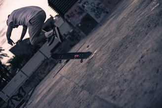 An action shot of a skateboarder mid-air, frozen with sharp clarity against a moody, overcast sky.