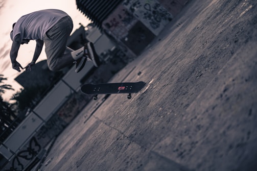 An action shot of a skateboarder mid-air, frozen with sharp clarity against a moody, overcast sky.