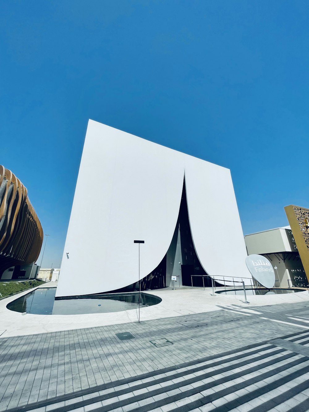 a large white building sitting on top of a street