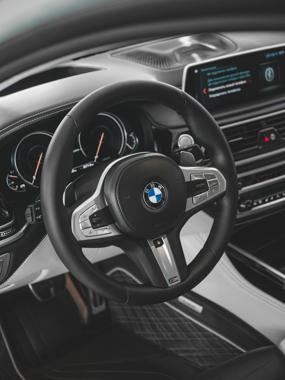 the interior of a car with a steering wheel and dashboard