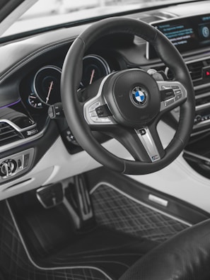 the interior of a car with a steering wheel and dashboard