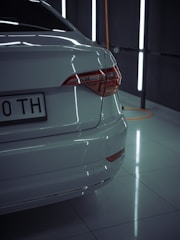 Rear and front parking sensors being installed on a sleek vehicle