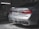 A luxury car in a dimly-lit garage is being washed, with soap suds covering the back of the vehicle. The car is silver and features distinctive red taillights and dual exhaust pipes. A license plate is visible, and cleaning equipment can be seen in the garage background.