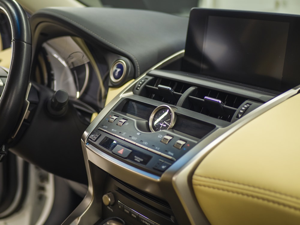 the interior of a car with a steering wheel and dashboard