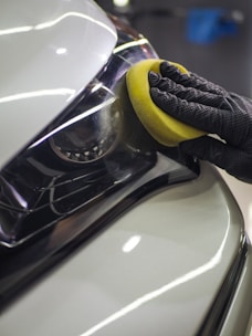 a person with a sponge on a car