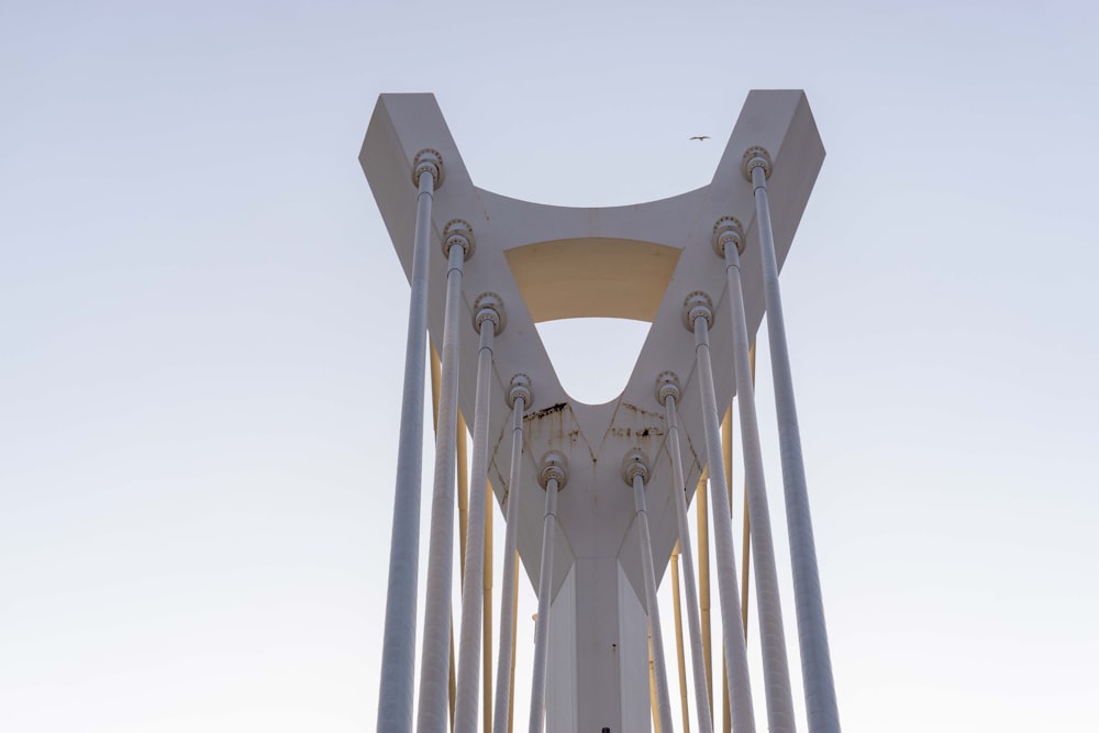 a tall white bridge with a sky in the background