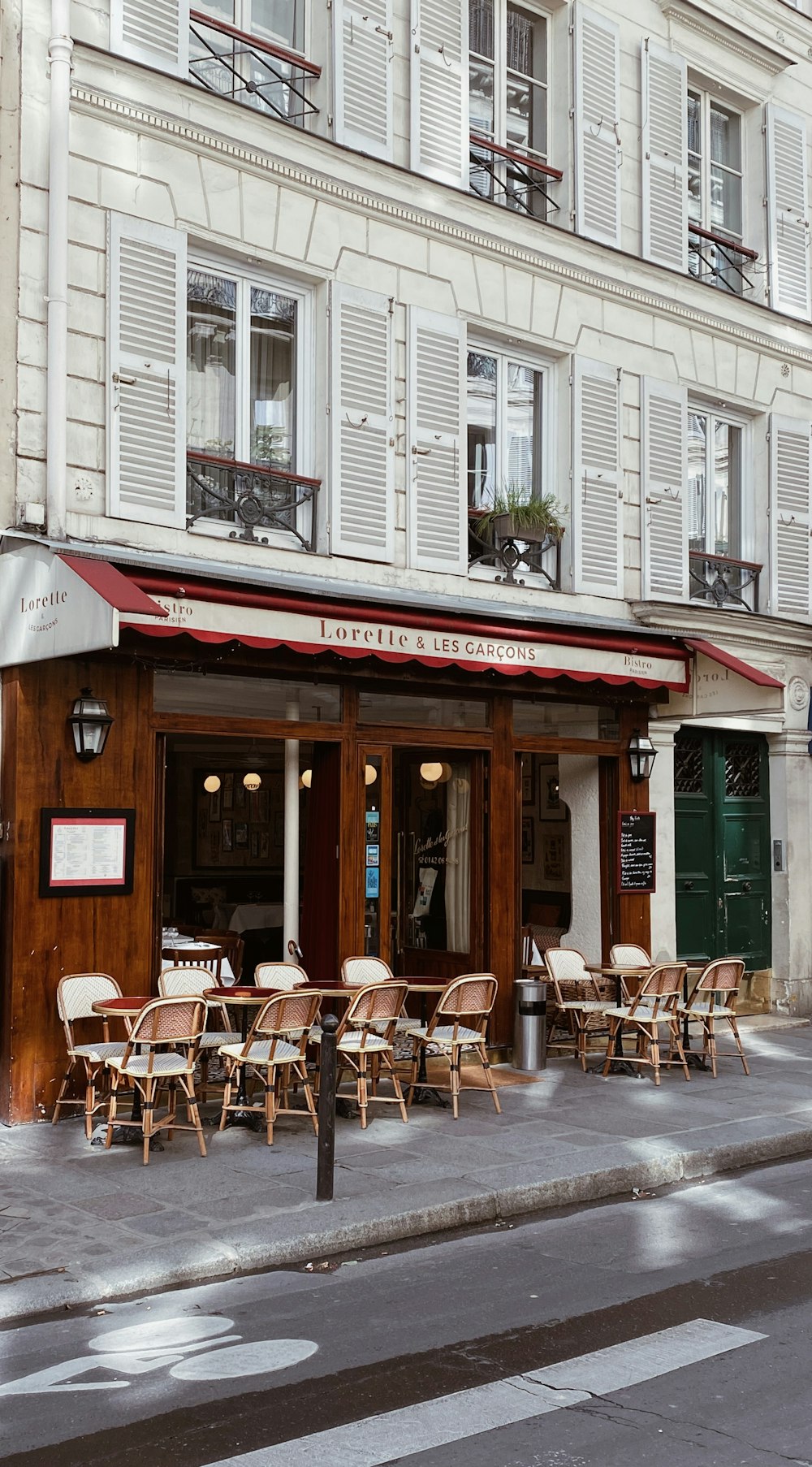 a street corner with tables and chairs outside of a restaurant