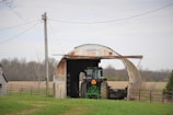 a tractor parked in front of a barn