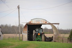 a tractor parked in front of a barn
