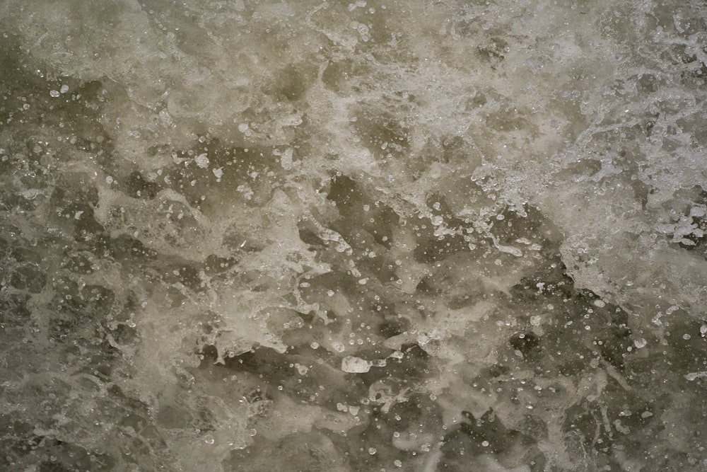 a black and white photo of water and rocks