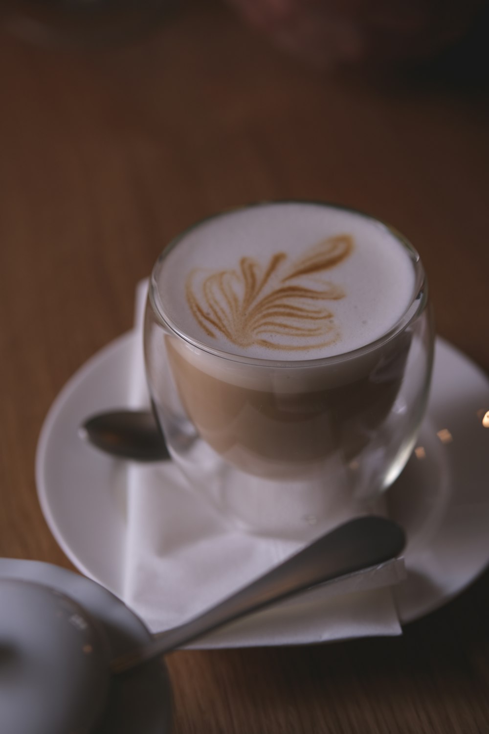 a cappuccino on a saucer with a spoon