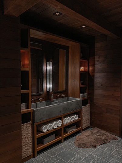 a bathroom with a large sink and wooden walls