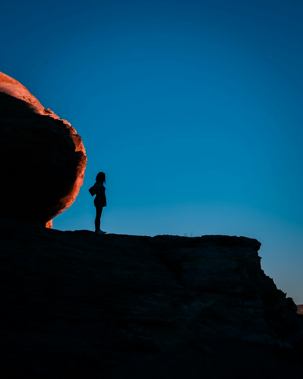 a person standing on top of a cliff