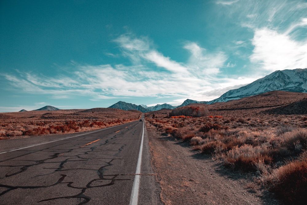 an empty road in the middle of a desert